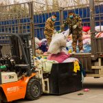 KingAAA workers unloading incoming used clothing supply at Guangzhou sorting facility.