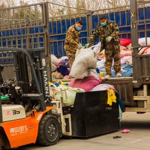 KingAAA workers unloading incoming used clothing supply at Guangzhou sorting facility.