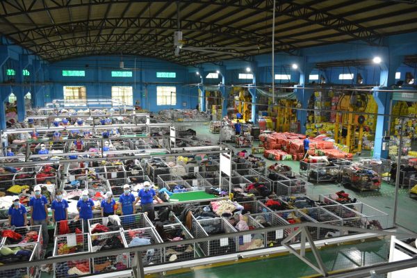 Authentic high-angle photograph of King AAA Guangzhou 20,000 sqm sorting floor illustrating why seeing the factory matters for used clothing importers